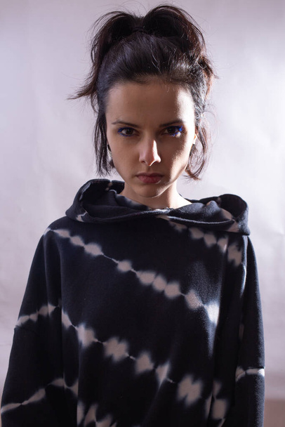 girl in a black hoodie on a white background - Fotoğraf, Görsel