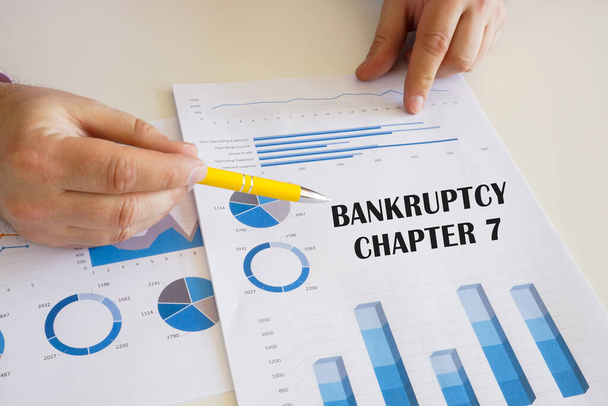 Business concept meaning BANKRUPTCY CHAPTER 7 with sign on the chart sheet. - Фото, зображення
