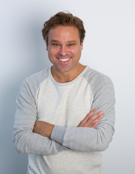 Mature man smiling with arms crossed - Foto, immagini