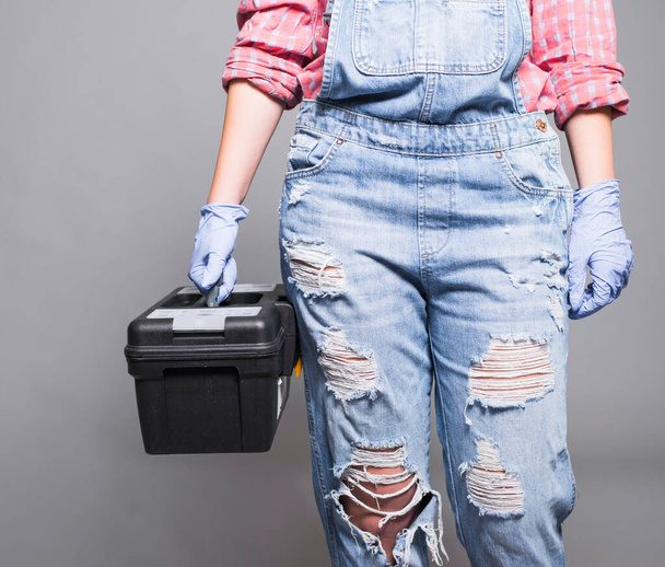 woman overall holding tool box. High quality photo - Foto, afbeelding