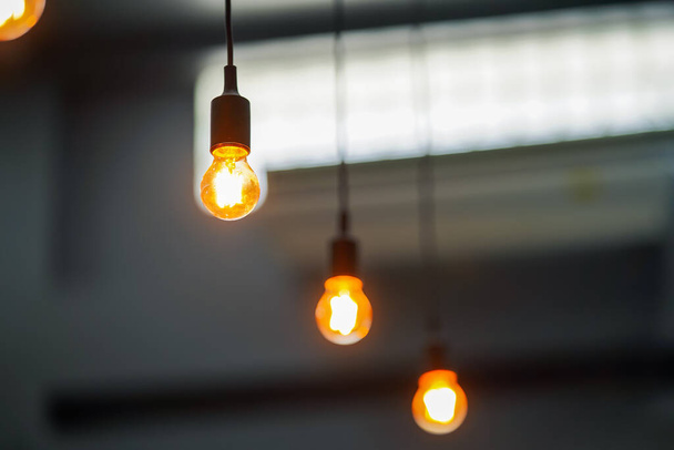 Light bulbs hanging from the ceiling, coffee lighting decoration ideas. - Photo, Image