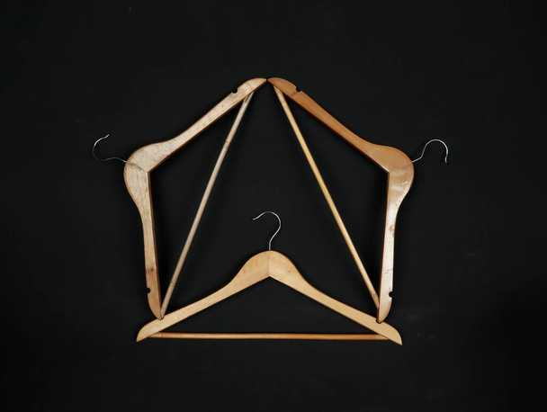 wooden hangers on the black background - Photo, Image