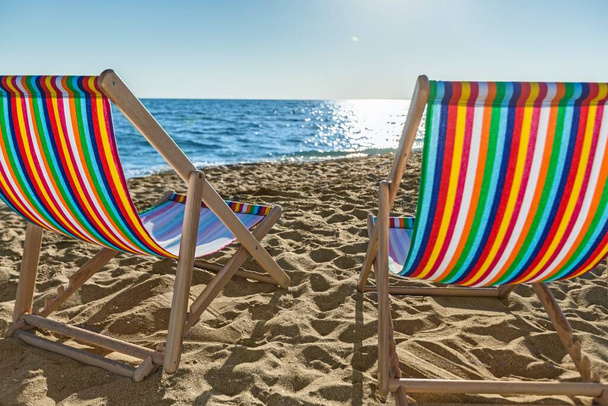 beach chairs on the sandy shore - Fotoğraf, Görsel