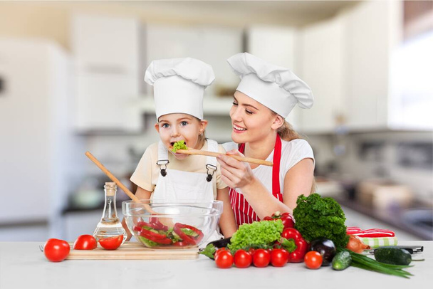 Cheerful happy mom teaching daughter how to prepare salad - Φωτογραφία, εικόνα