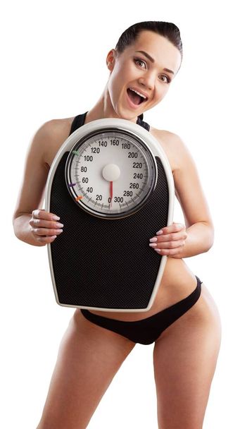 Girl holding scales, lose weight concept - Φωτογραφία, εικόνα