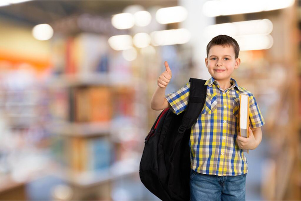 school boy with book and backpack showing thumb up - Foto, Imagem