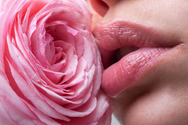 Lips closeup. Beautiful woman lips with rose. - Photo, Image