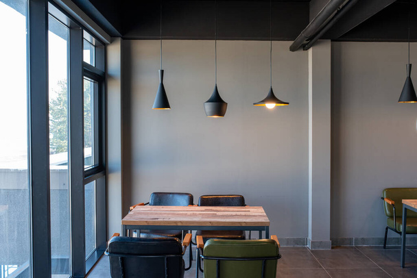 An indoor cafe setting with hanging lamps - Foto, afbeelding