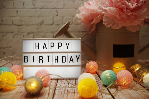 Happy Birthday text on lightbox on wooden background - Фото, изображение
