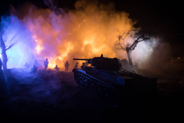 War Concept. Military silhouettes fighting scene on war fog sky background, World War Soldiers Silhouette Below Cloudy Skyline At night. Armored vehicle fight scene. Selective focus - Photo, Image