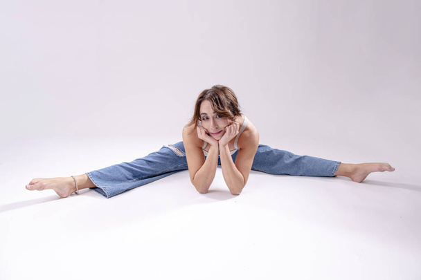 Portrait of beautiful young woman with athletic flexible body doing yoga.  isolated - Photo, Image
