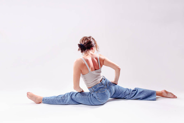 Portrait of beautiful young woman with athletic flexible body doing yoga.  isolated - Фото, изображение