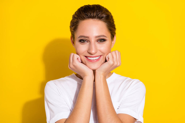 Photo of sweet brown short hairdo young lady hands face wear white t-shirt isolated on yellow color background - Fotografie, Obrázek