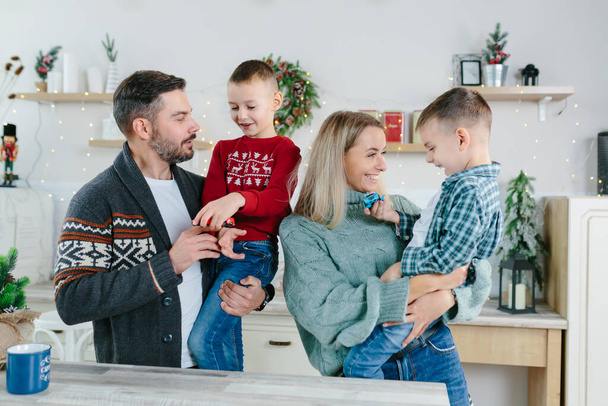 Cheerful happy married couple with two children waving hands laughing having fun at home for Christmas posing to camera indoor modern technology New Year congratulations to family or friends. - Foto, imagen