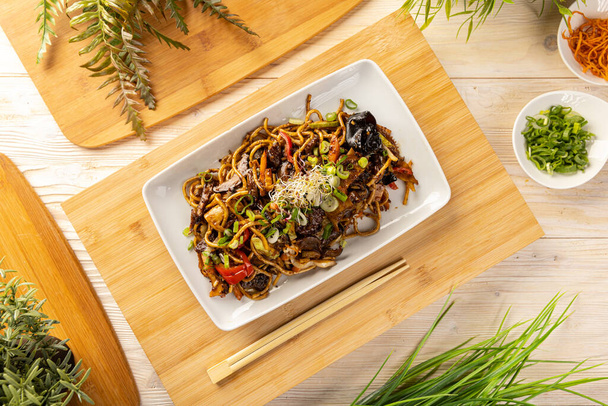 Top view of noodles stir fry with ear wood mushrooms and vegetables - Fotó, kép
