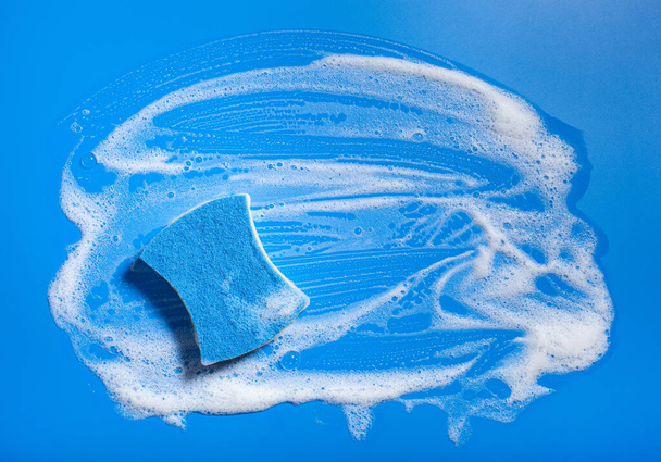 pulizia spugna pulire schiuma sapone suds su sfondo blu, concetto di lavaggio domestico - Foto, immagini