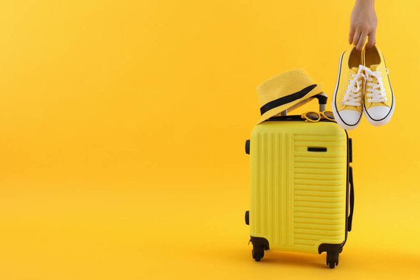 Samenstelling met reisaccessoires op gele achtergrond - Foto, afbeelding