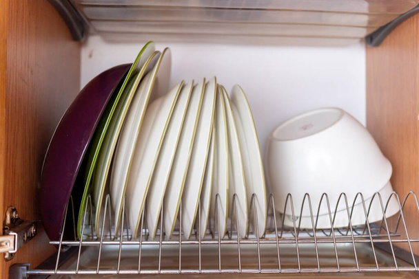 washed dishes in a cupboard close-up - Foto, Bild