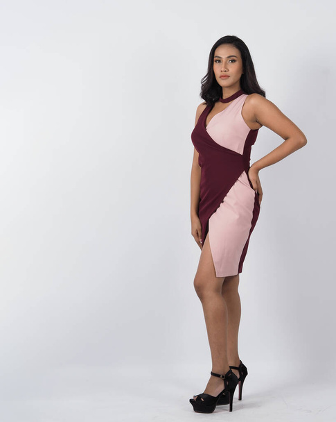 Asian woman full body. Thai woman in a modern chic style stands in white studio with elegant and confident pose. Casting model supporting actor actress. Asian woman fullbody pose in front of camera. - Zdjęcie, obraz