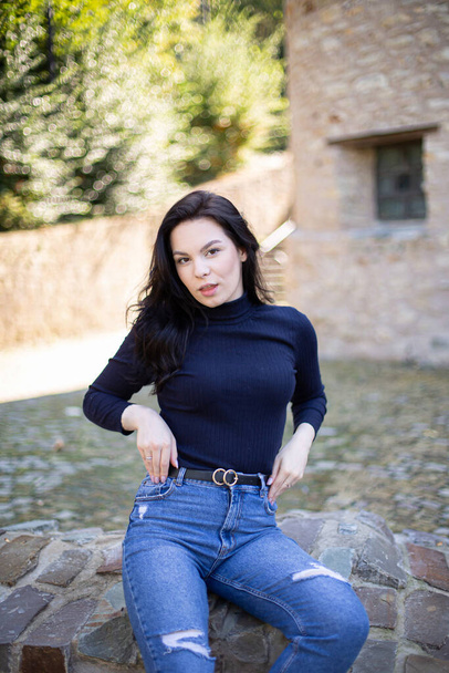 Young european girl with dark hair in jeans outside - Foto, immagini