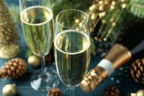 Concept of New Year celebration with champagne on wooden table. - Foto, afbeelding