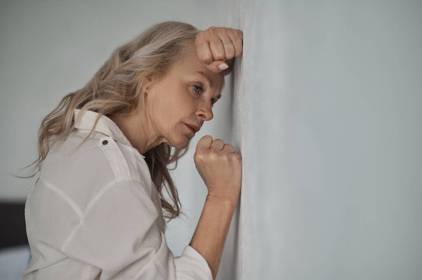 Dejected mature blonde woman suffering from loneliness - Photo, Image