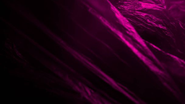 Plastik-Textur mit einer rosafarbenen neonleichten Textur. realistische Kunststoffstruktur für Overlay und Effekt. Trendiges Kunststoffmuster für kreatives und dekoratives Design. - Foto, Bild