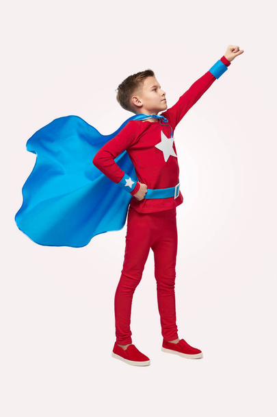 Fearless boy in superhero costume in studio - Fotó, kép