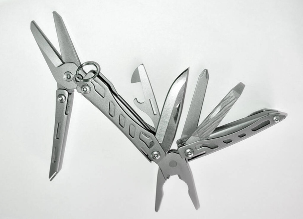 Miniature, pocket-sized universal Multi tool containing a knife, opener, pliers, scissors and a file. - Foto, Imagem