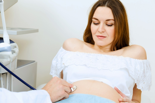 Pregnant woman examined by doctor - Photo, image