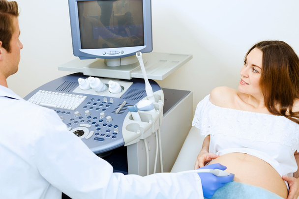 Pregnant woman examined by doctor - Fotoğraf, Görsel