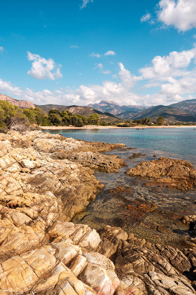 The rocky coastline and secluded beach of Plage de Chiuni and turquoise Mediterranean sea on the west coast of Corsica - Valokuva, kuva