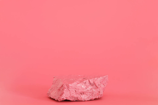 Pink stone, rock podium on the pink background. Podium for product, cosmetic presentation. Creative mock up. Pedestal or platform for beauty products. - Zdjęcie, obraz