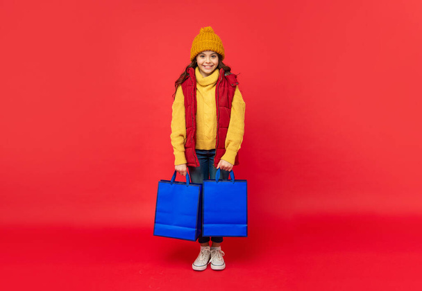 black friday discount. seasonal christmas sales. happy teen girl in with shopping bag. - Photo, Image