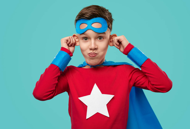 Child in superhero costume making funny faces - Zdjęcie, obraz