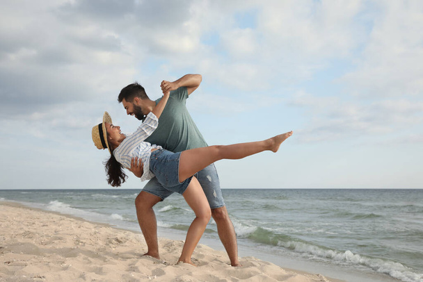 Lovely couple dancing on beach. Time together - Фото, изображение