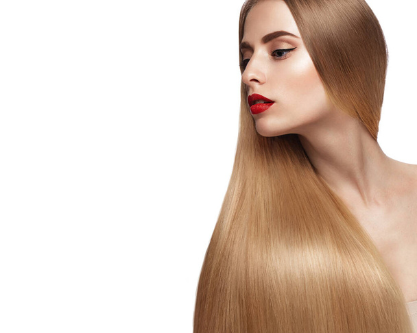 Beautiful blond girl with a perfectly smooth hair, and classic make-up. Beauty face and hair. - Фото, изображение