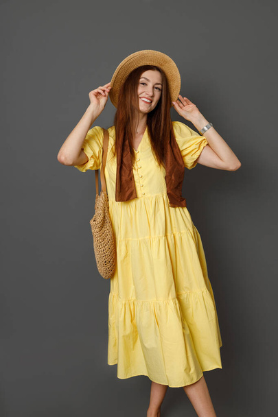 Joyful woman in summer dress standing in studio - Fotoğraf, Görsel