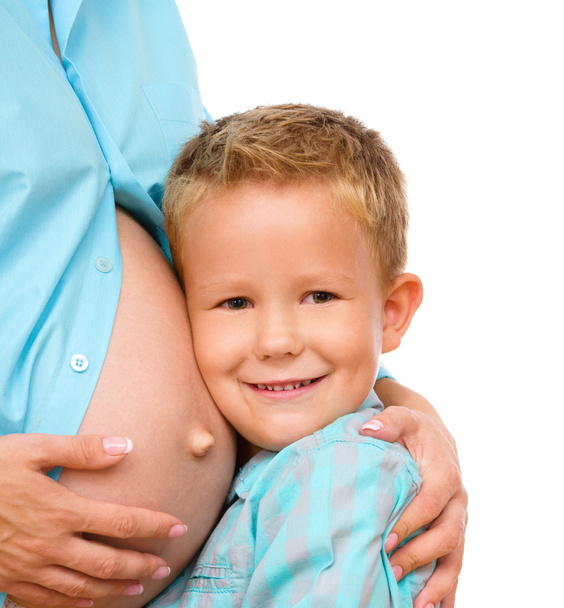 Happy child holding belly of pregnant woman - Photo, image