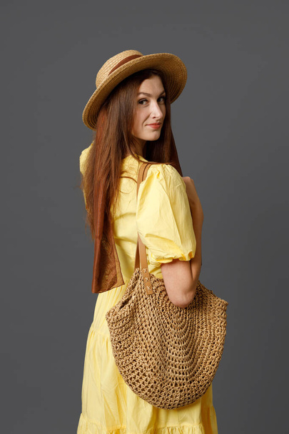 Attractive woman in straw hat standing in studio - Photo, Image