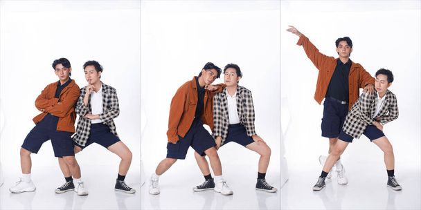 Full length of 20s Asian tanned skin men black hair hold together as Gay LGBT, wear shirt pants blazzer sneaker shoes. Young Couple modern dance with fun happy over studio white background isolated - Photo, Image