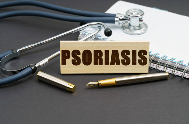 Medicine concept. On the table is a notebook, a stethoscope and a sign with the inscription - PSORIASIS - Photo, Image