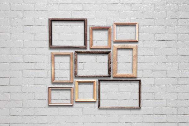 old photo frames on white brick wall - Photo, Image