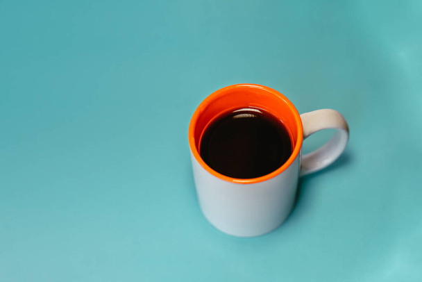 A mug of coffee on a blu background - Fotoğraf, Görsel