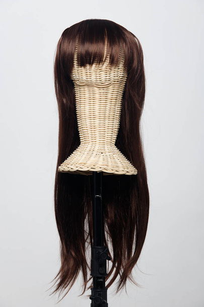 Brown brunette long straight hair wig on mannequin rattan head over white background isolated, show many angle of hair style wave and light point of view - Foto, Bild