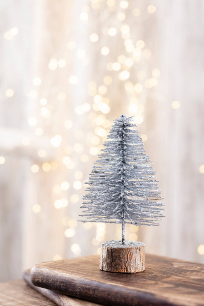 Christmas tree on wooden, bokeh background. Christmas holiday celebration concept. Greeting card. - 写真・画像