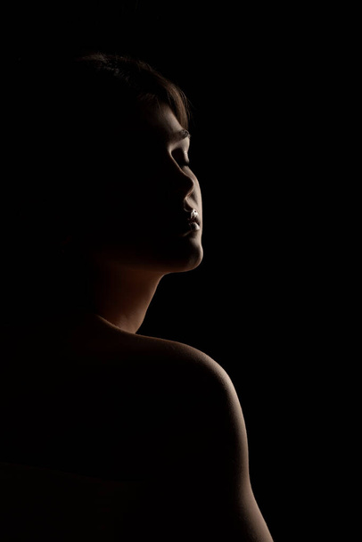 sensual portrait silhouette of a young beautiful woman against a black background - Foto, Imagem
