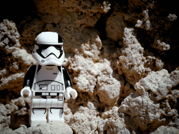 Chernihiv, Ukraine, July 13, 2021. A minifigure of an imperial stormtrooper from Star Wars against a background of sandy terrain. Illustrative editorial. - Fotó, kép