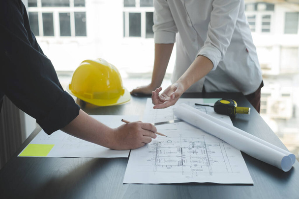 Team of engineers and architects, working team, meeting, discussing construction and drawing construction plans, printing, writing on-site construction sites. Home design concept. - Foto, imagen