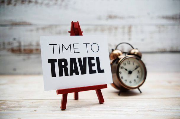 Time to Travel text and alarm clock on wooden background - Photo, Image